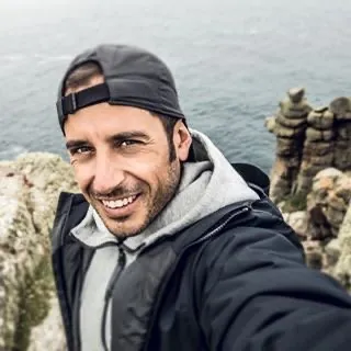 Man smiling by the sea, photographed by GCShutter