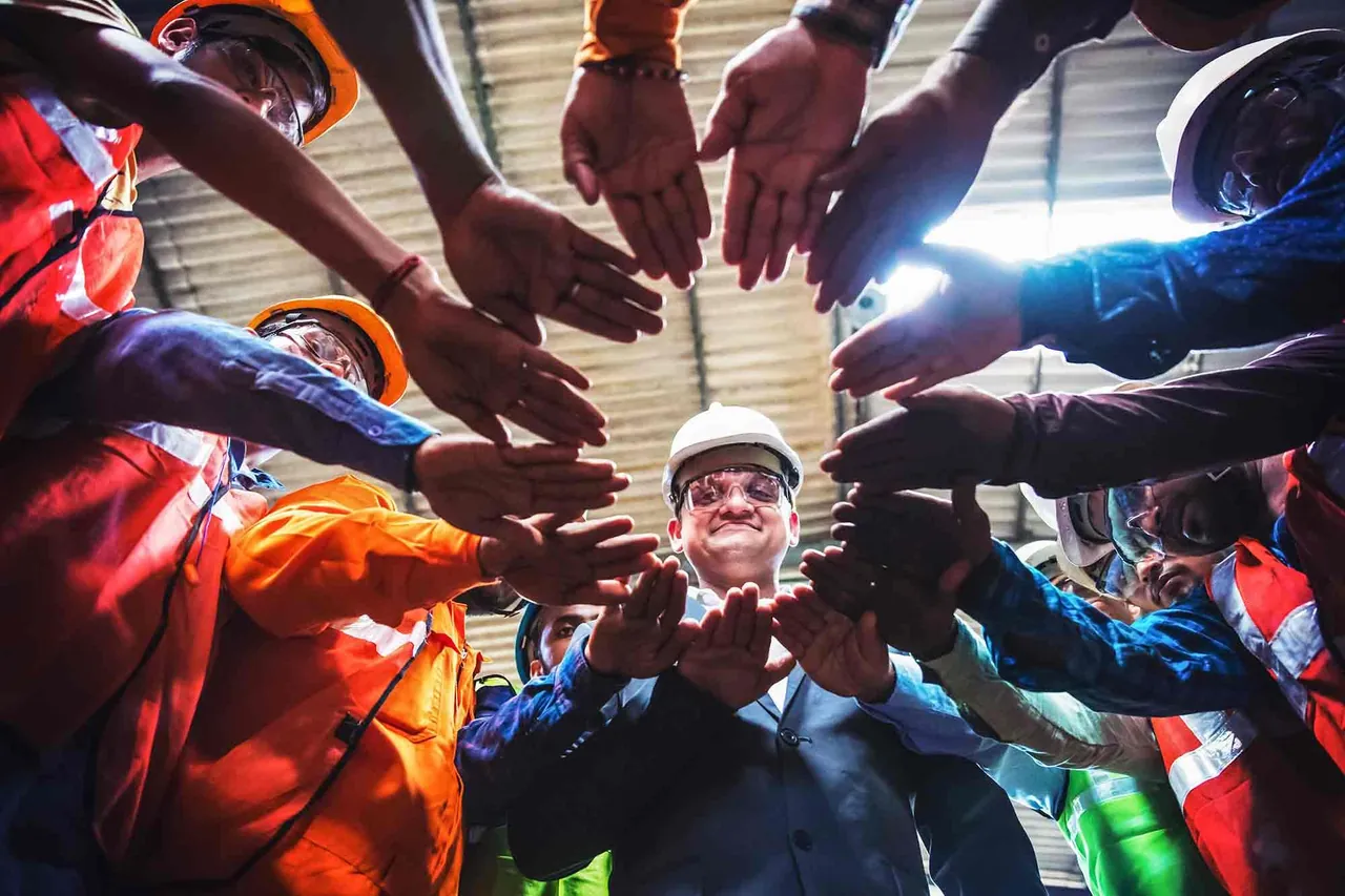 Team joining hands in a circle, photographed by GCShutter